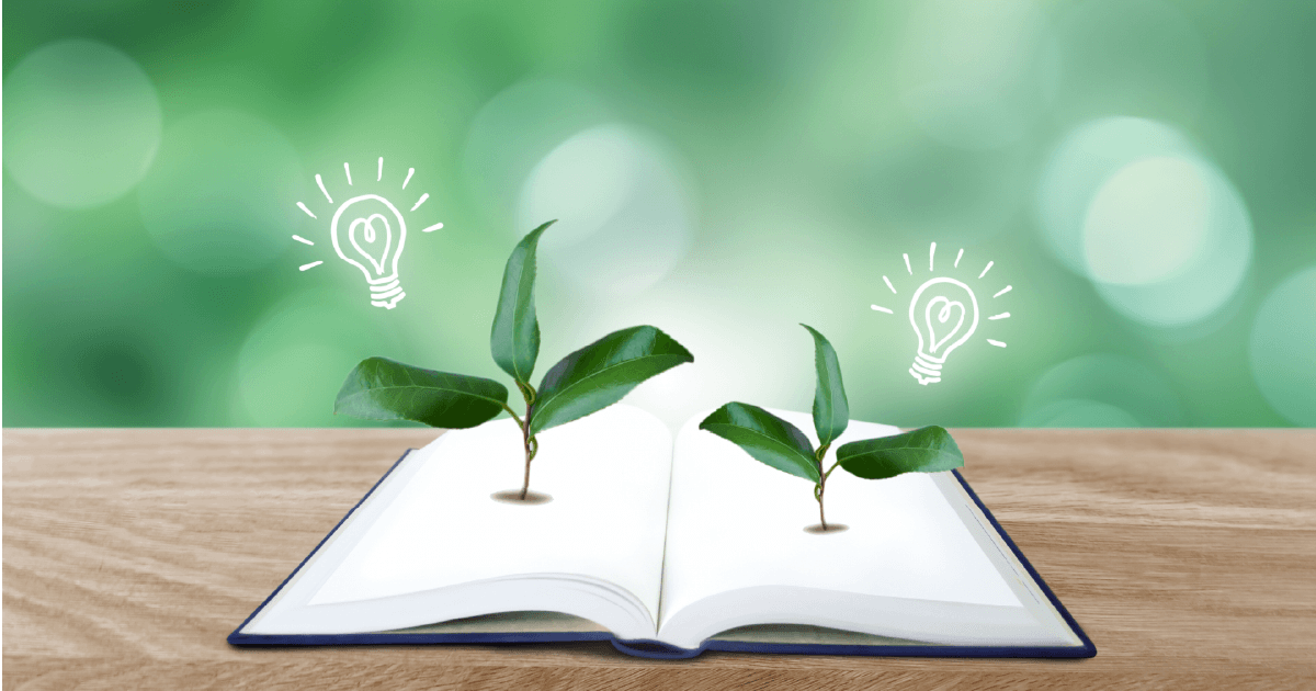 開いた本と葉っぱと電球マーク